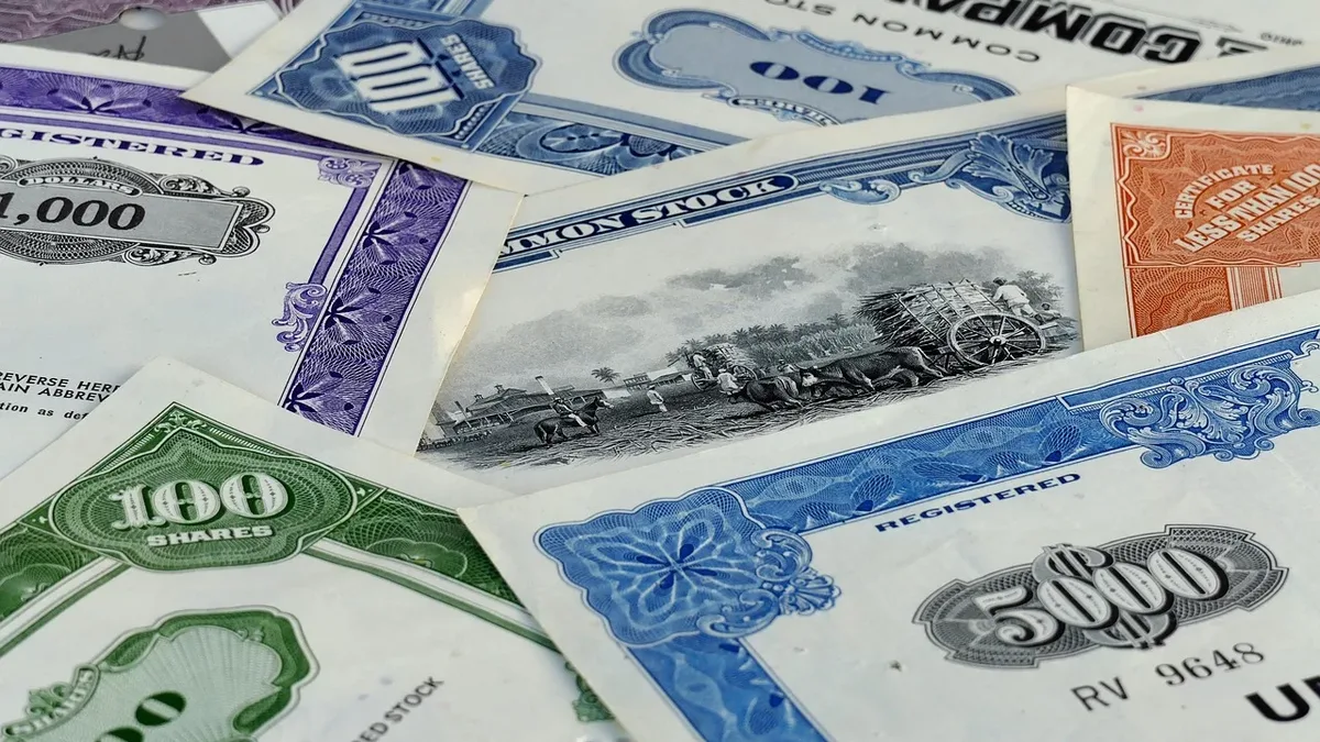 A collection of stock certificates, each featuring a unique design and color scheme, with some displaying the company name and others bearing the number of shares.